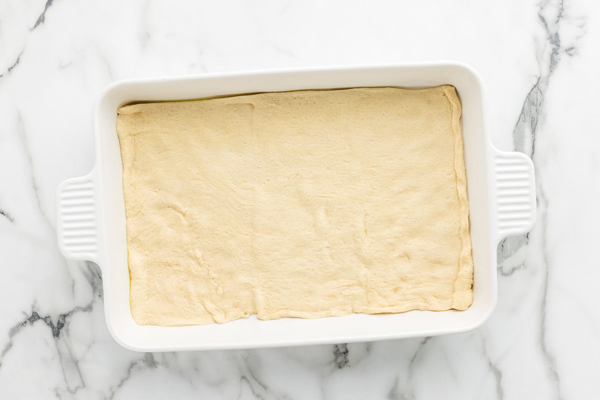 Crescent roll in the bottom of a baking dish.