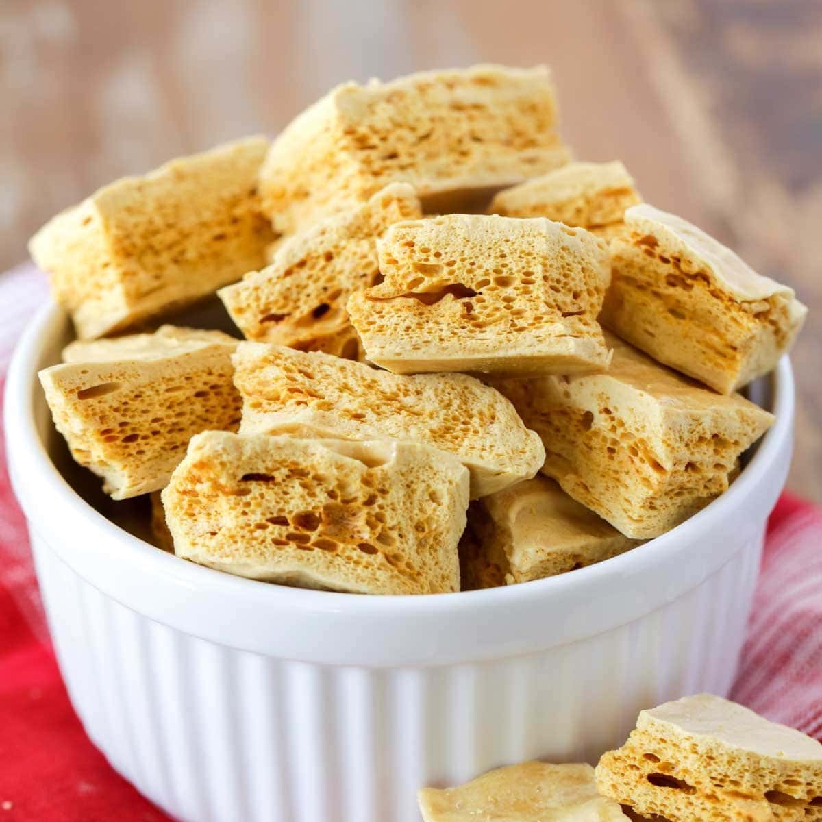 Sponge candy recipe pieces broken up in white bowl.