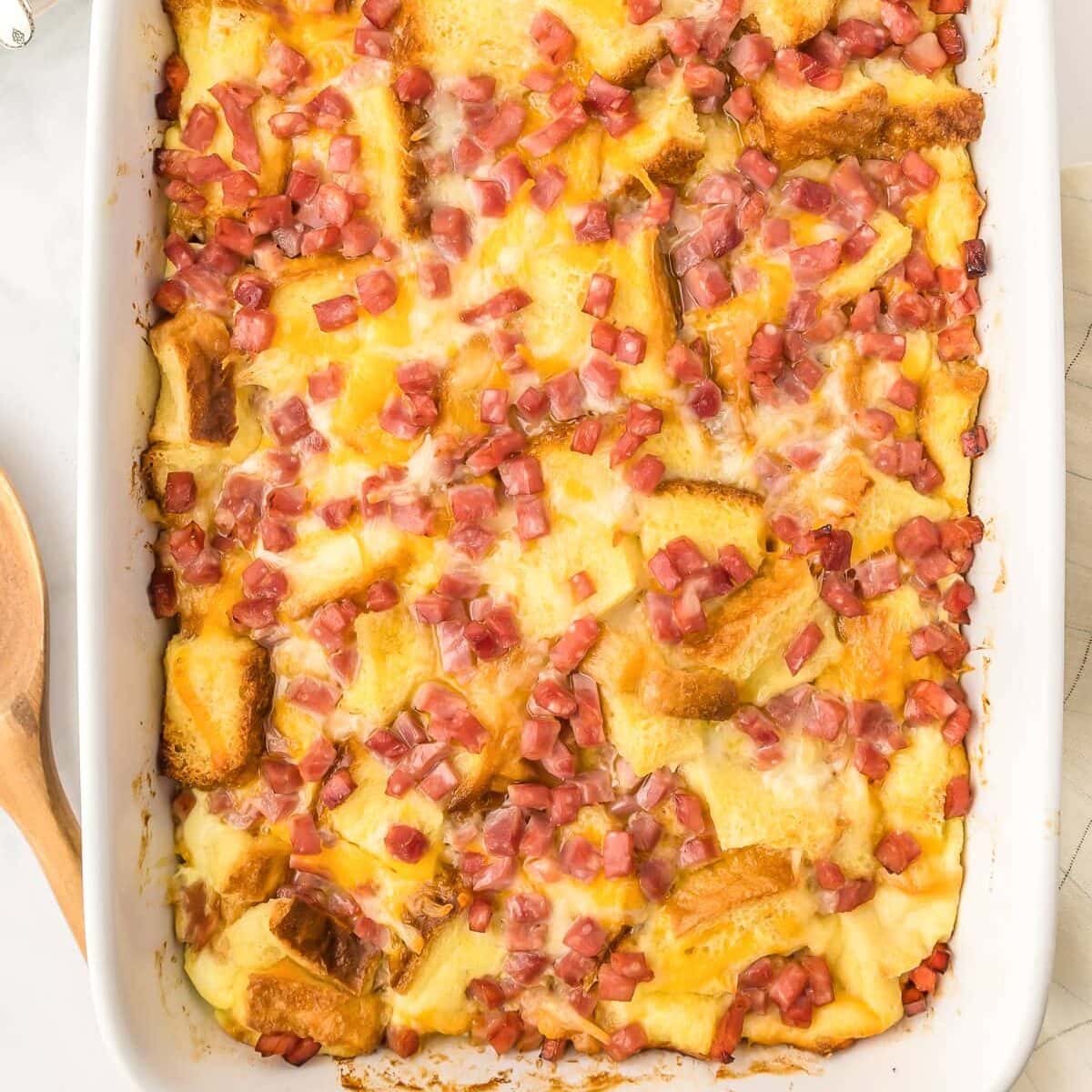 A close up of baked strata recipe in a glass baking dish.