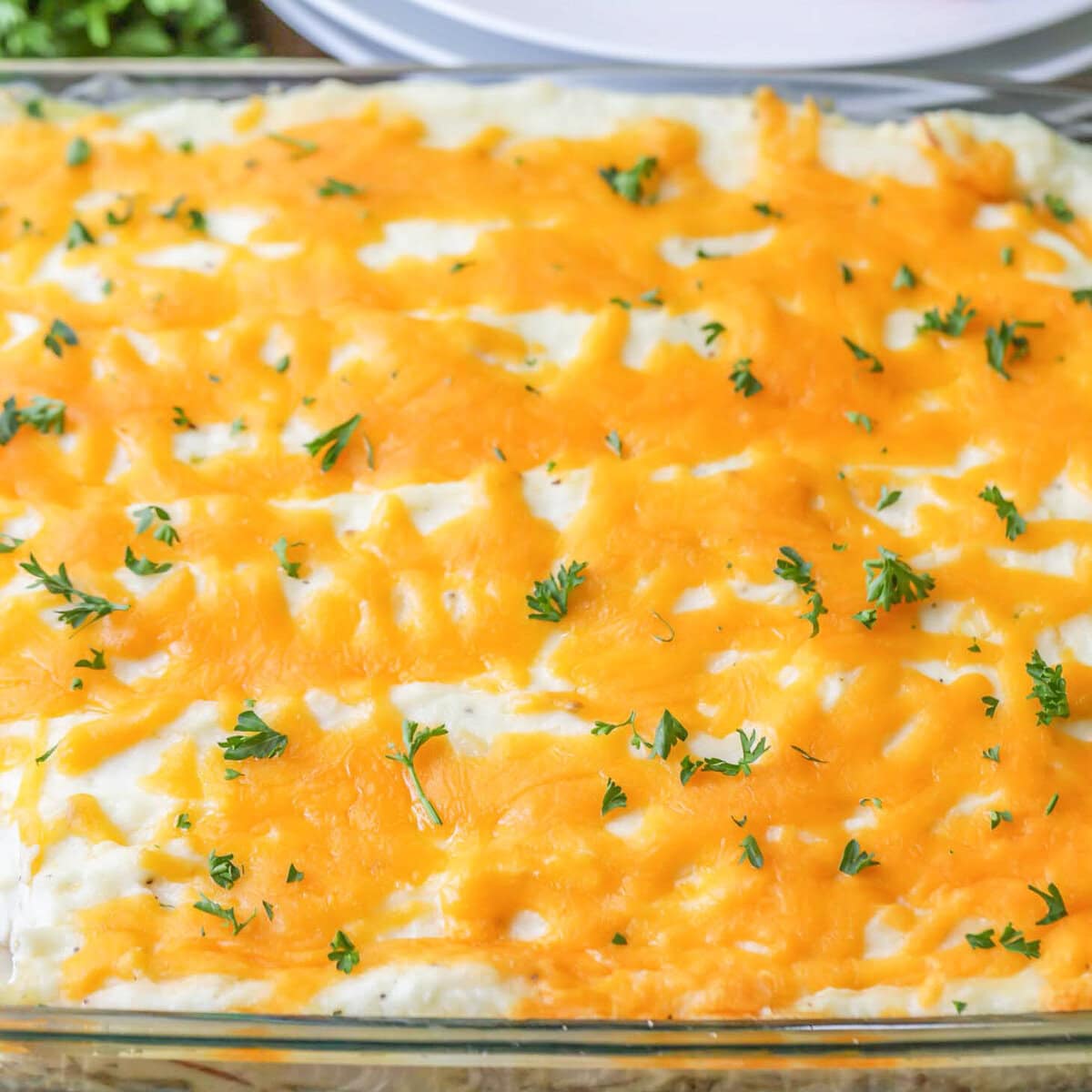 Close up image of Thanksgiving leftover casserole in glass baking dish.