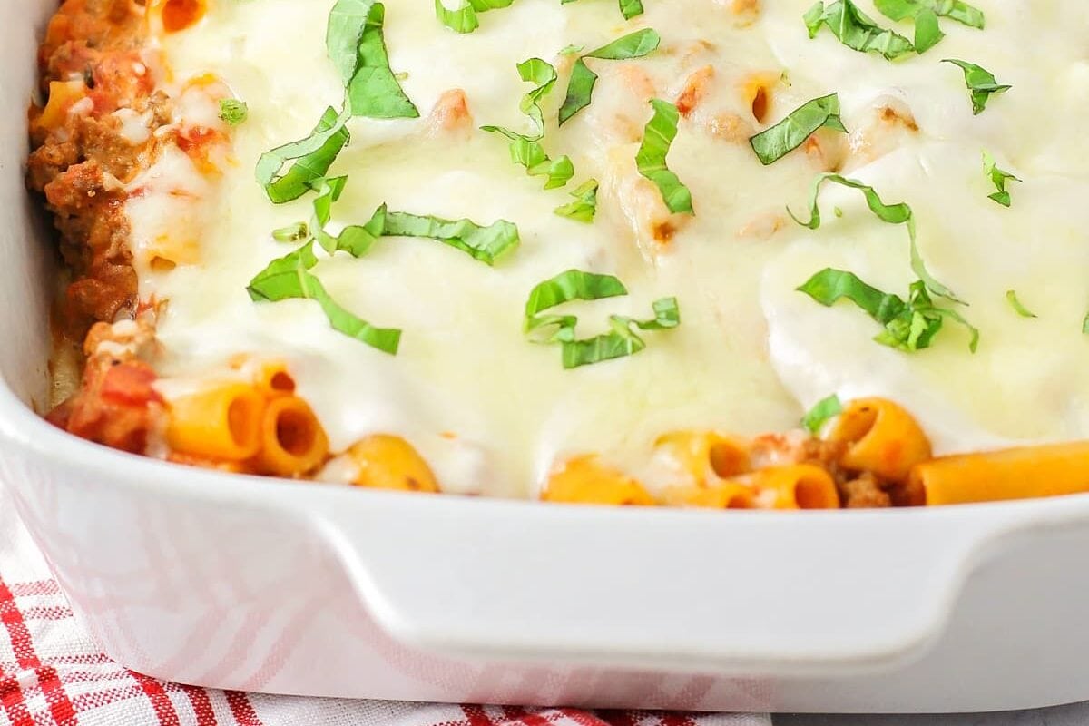 A baked dish filled with easy baked ziti recipe topped with melted mozzarella.