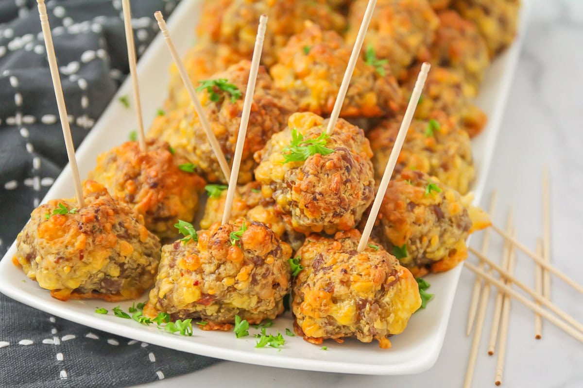 Close up image of Bisquick sausage balls on a white platter.