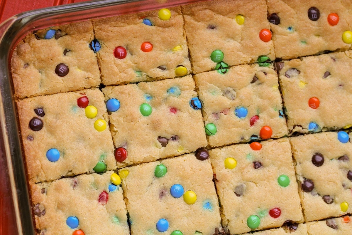 Cake mix cookie bars cut up in baking dish.