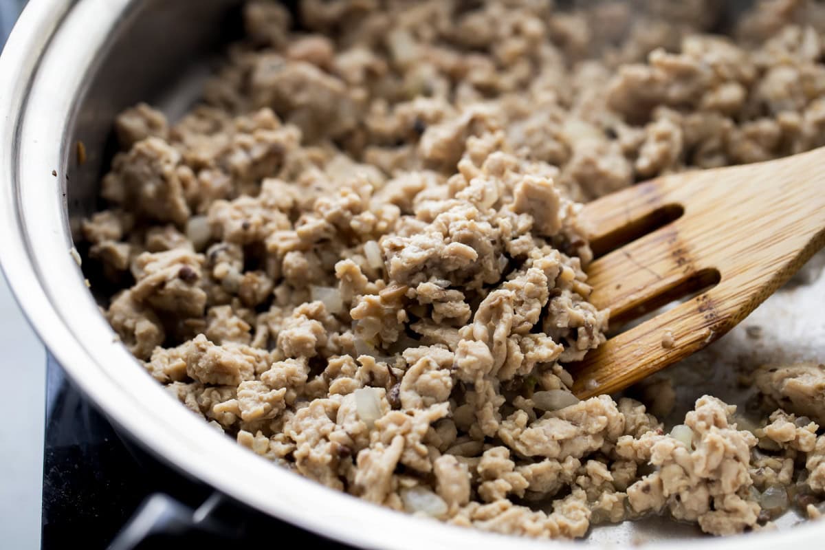 Ground chicken mixture for chicken lettuce wraps in a skillet.