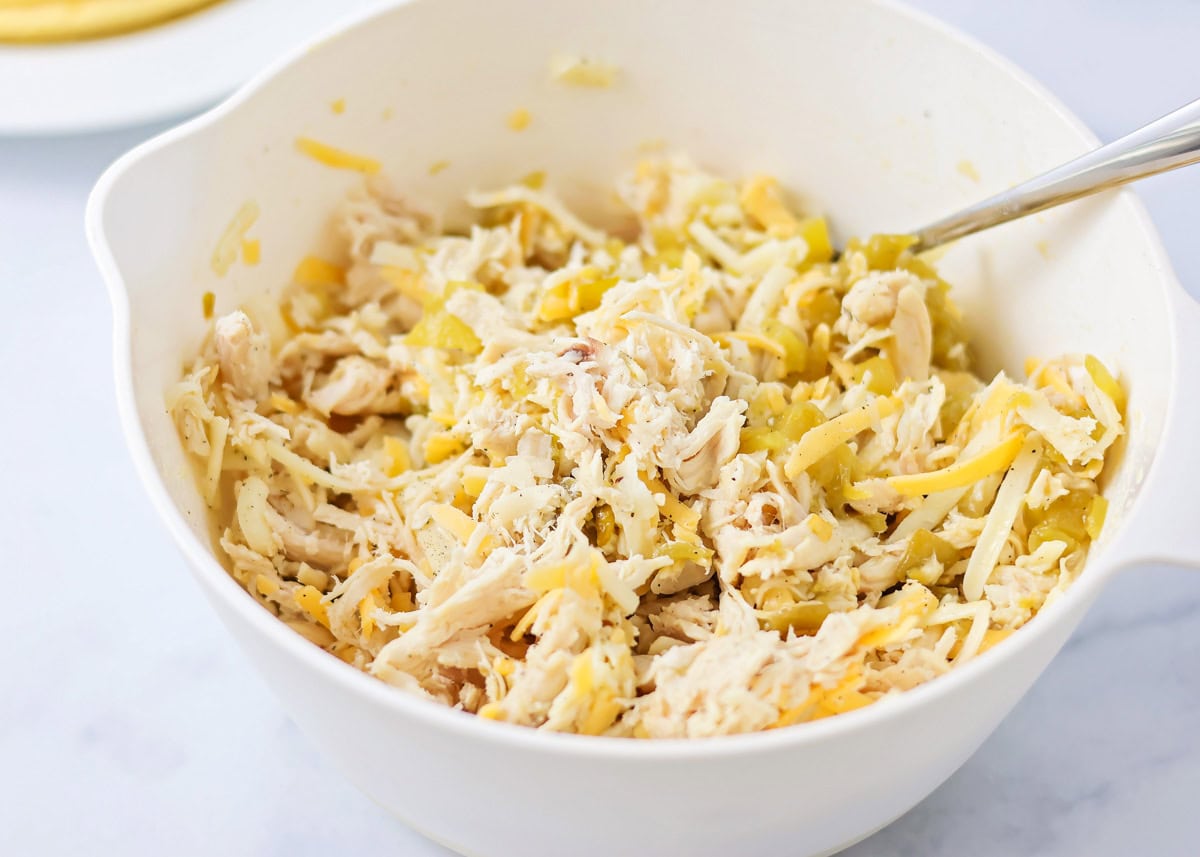 Chicken filling for tacos in white mixing bowl.