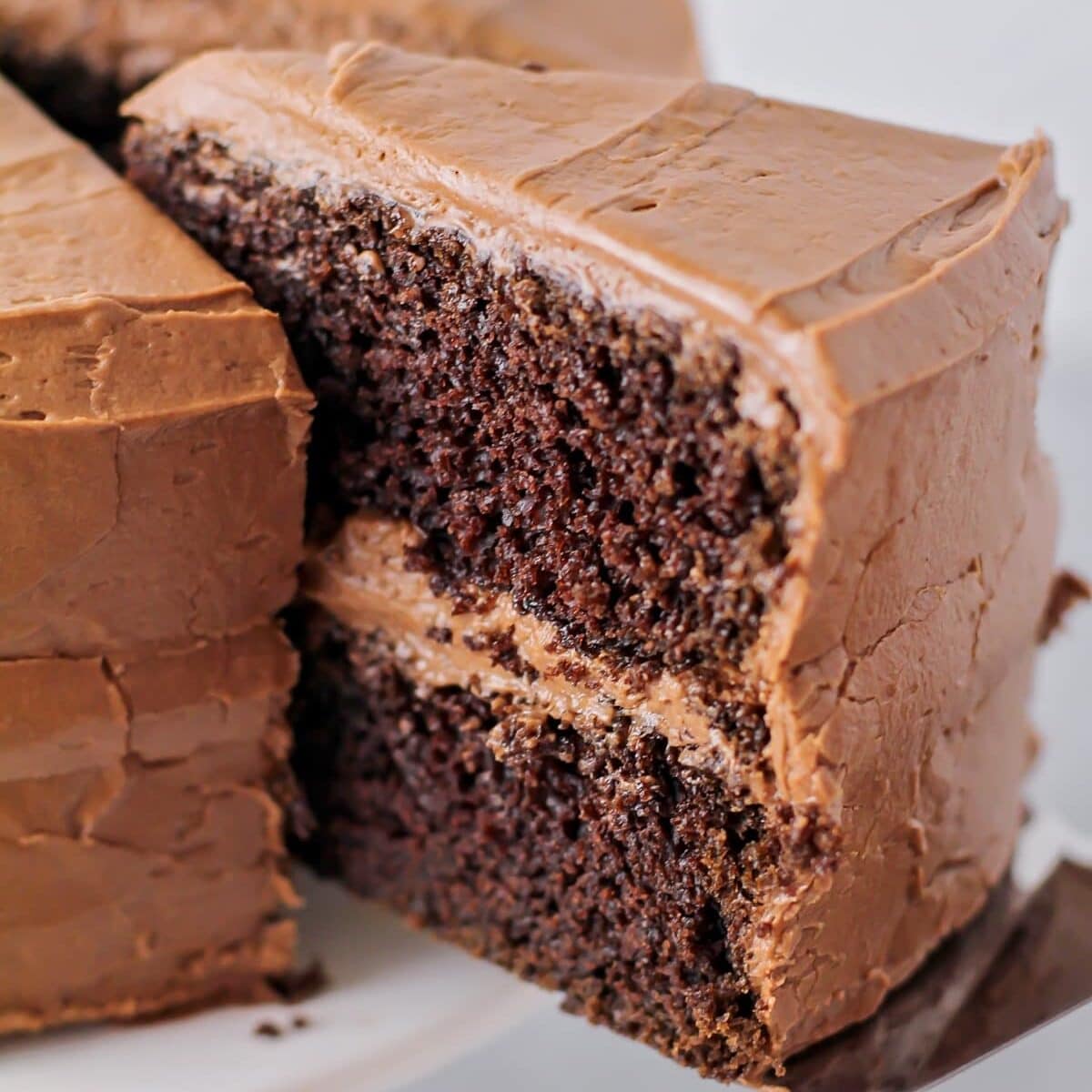 Slice of easy chocolate cake being dished out with a spatula.