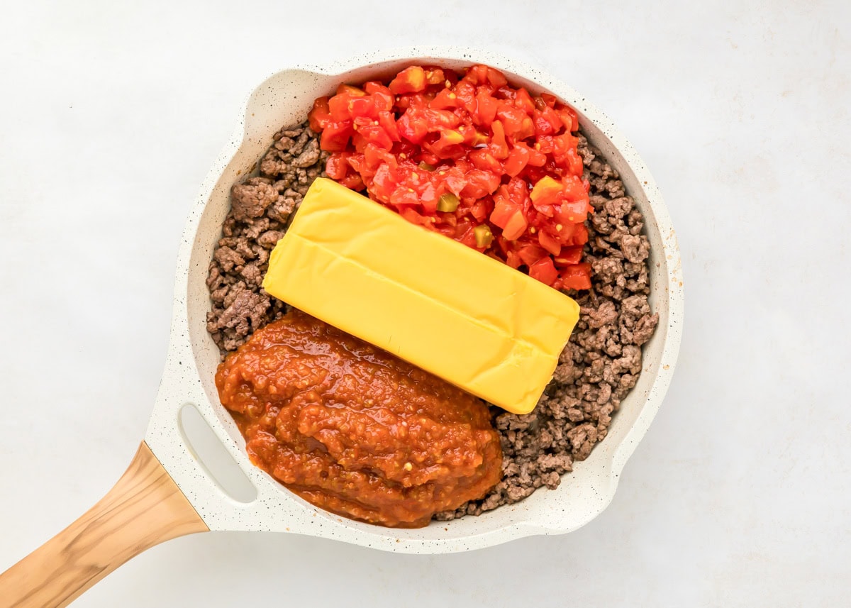 Ingredients for hamburger dip in skillet.