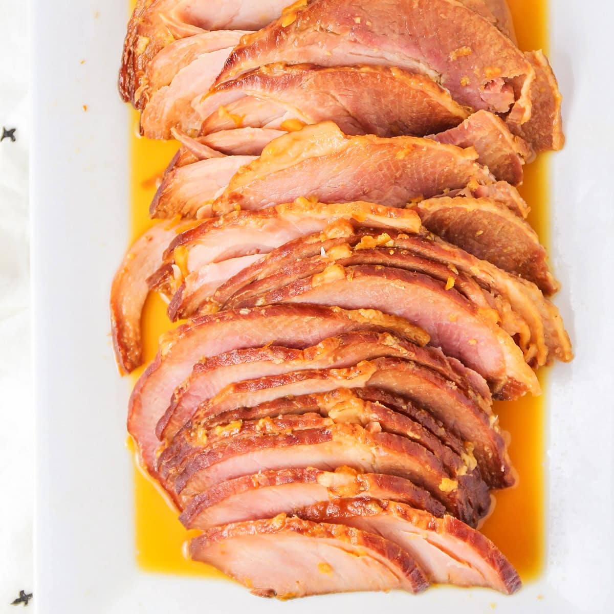 Slices of instant pot ham on a white serving platter.