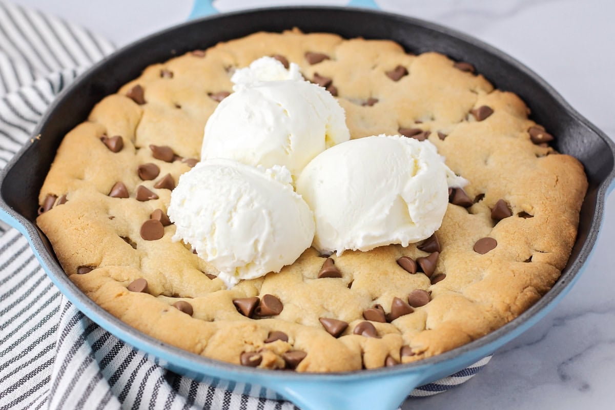 Close up image of pizookie recipe with ice cream on top.