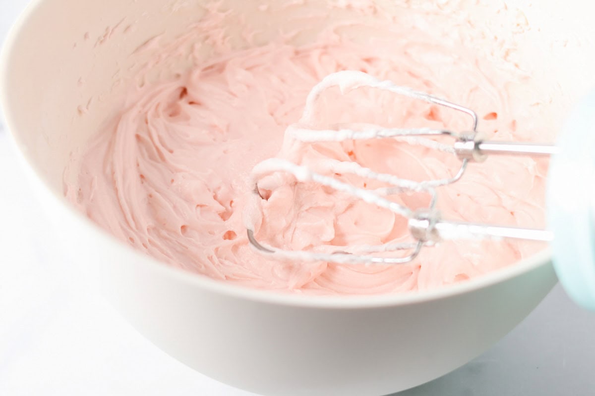 Light pink frosting in mixing bowl.