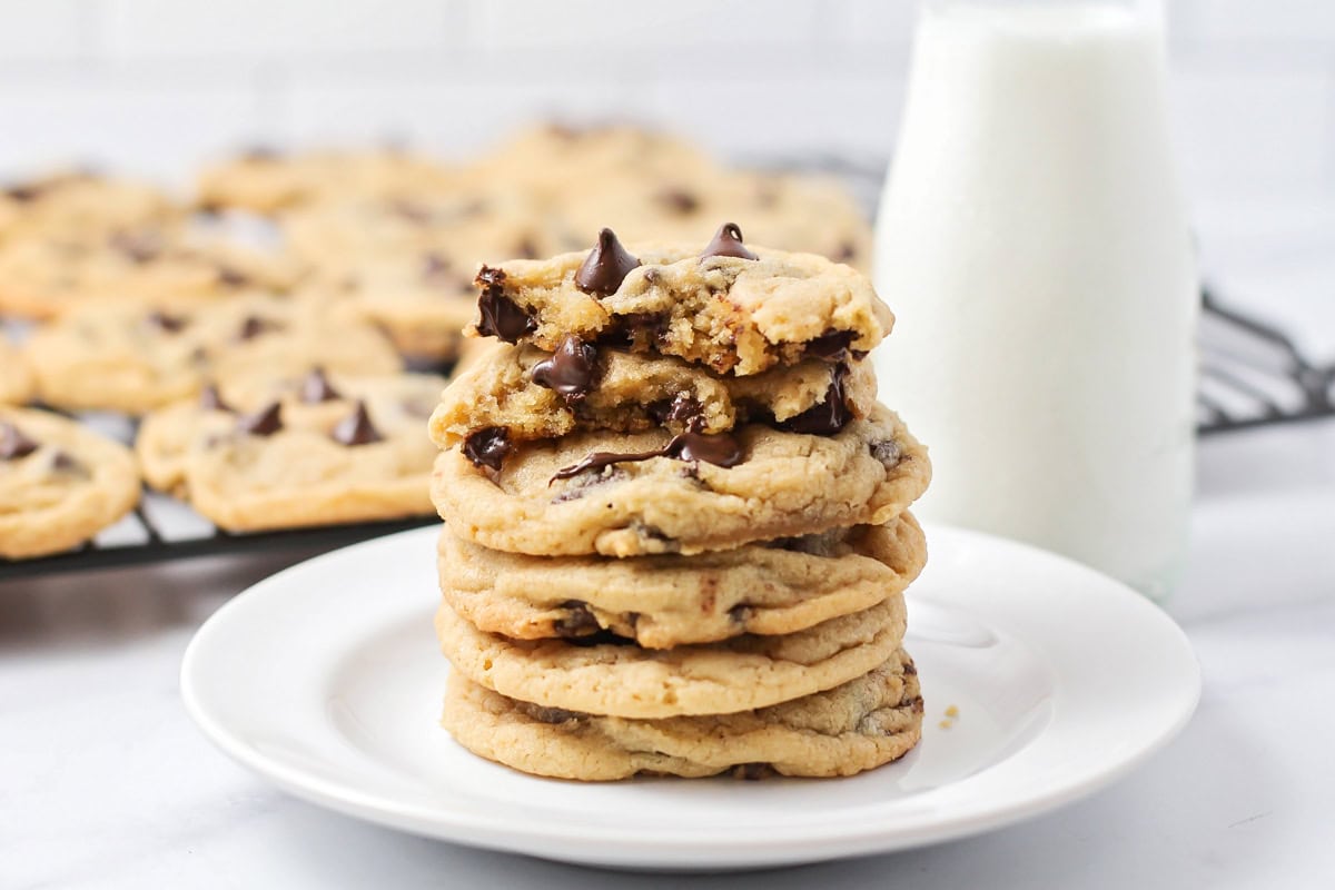 A stack of best chocolate chip cookies on a white plate.