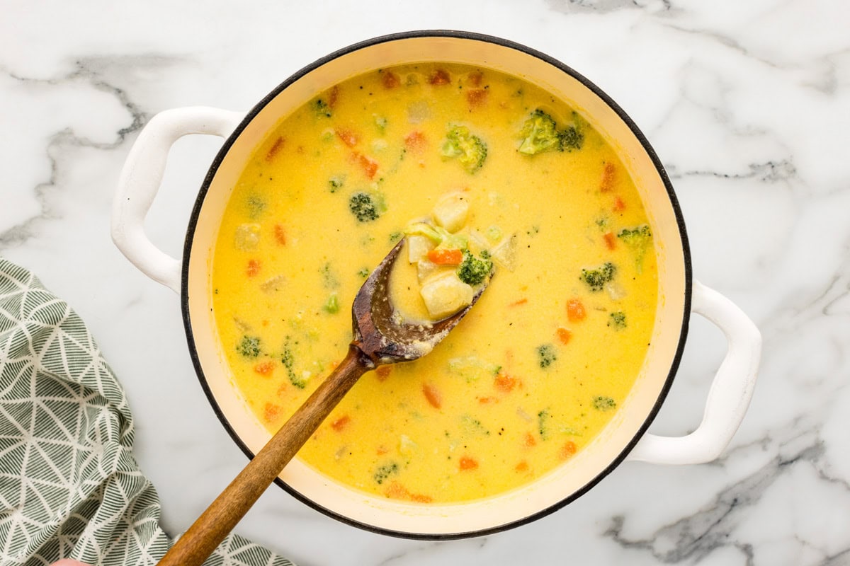 Mixing together ingredients for broccoli cheddar potato soup.