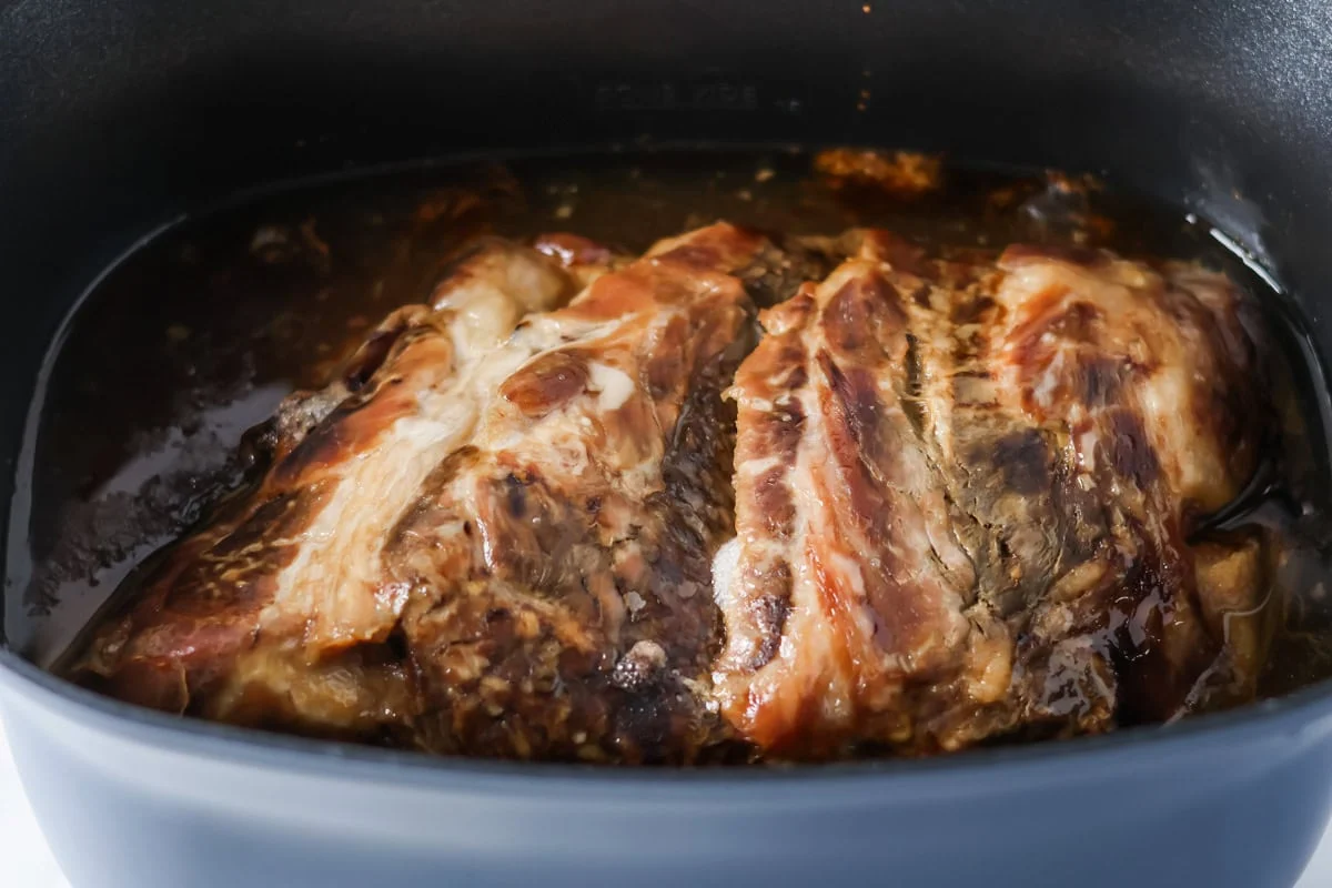 Pork butt cooking in a crockpot.