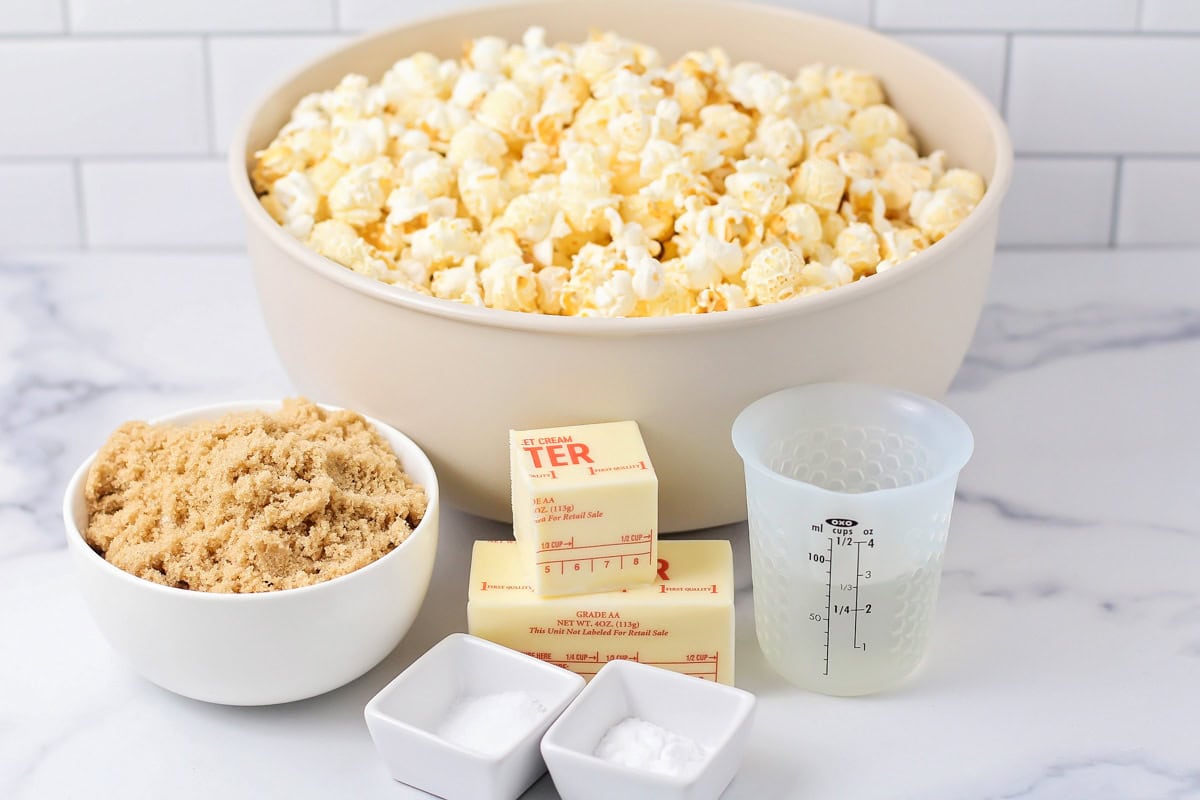 Ingredients for caramel popcorn on a marble countertop.