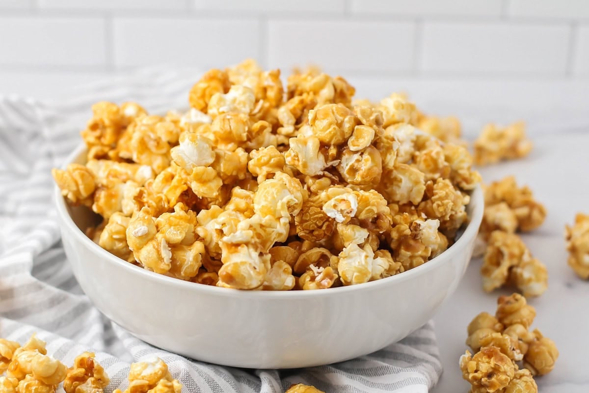 Homemade caramel popcorn in a white bowl.