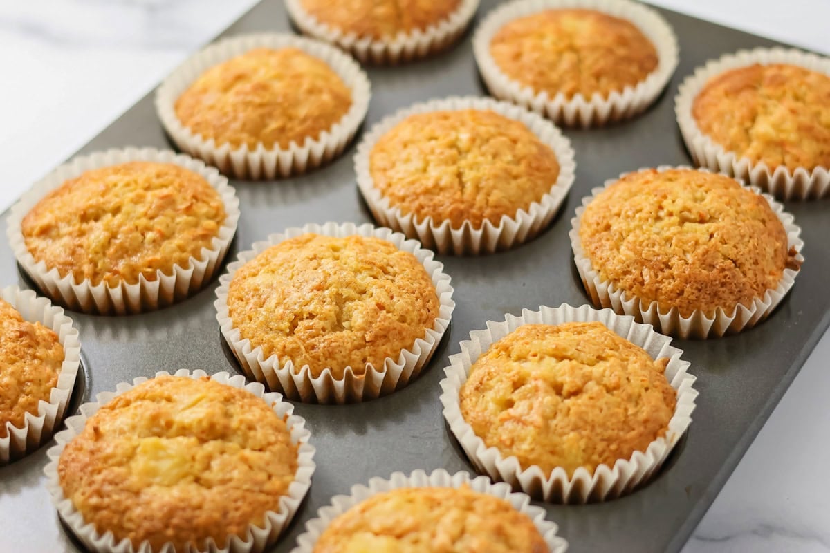 Baked muffins in a lined tin.