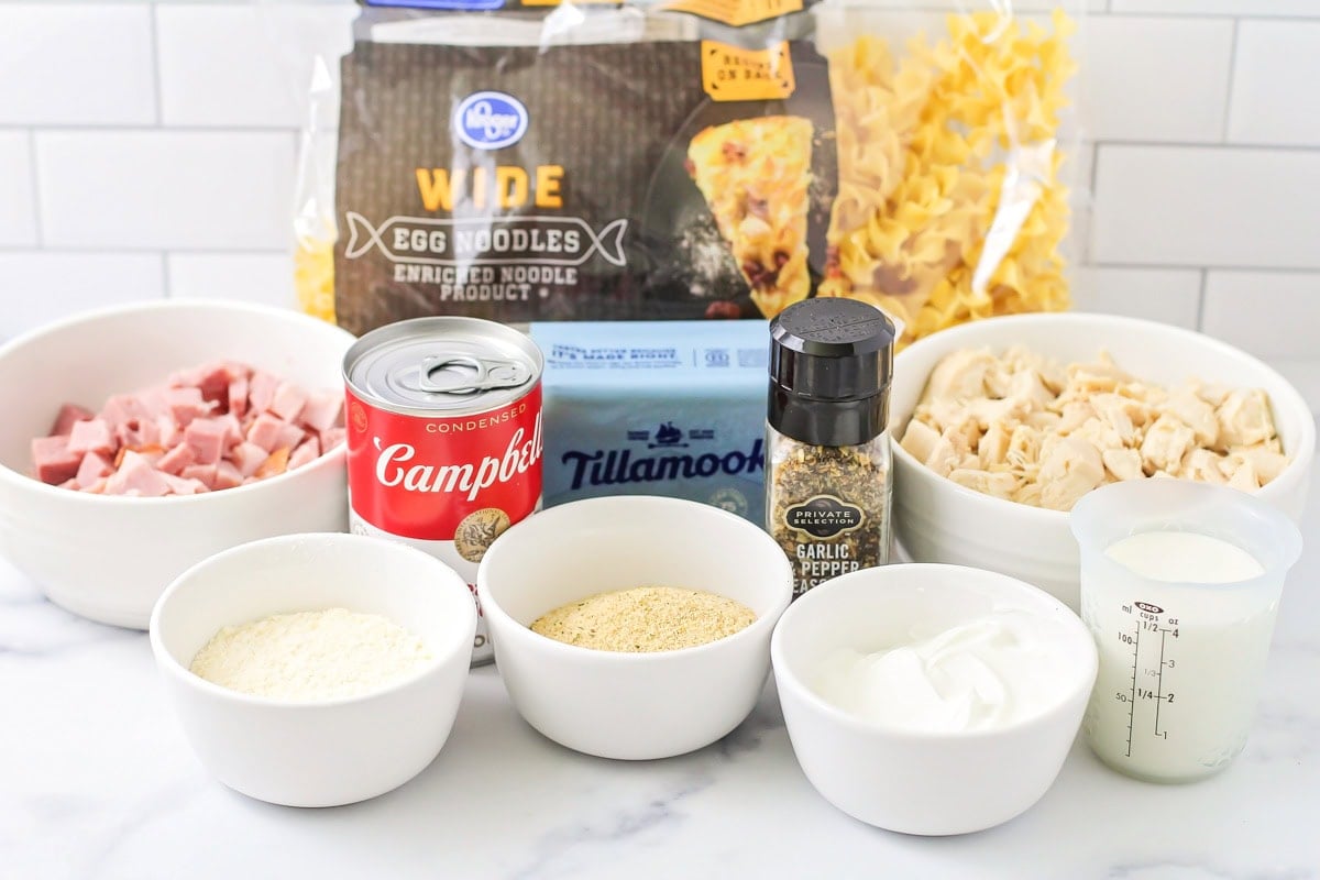 Chicken, pasta, and other ingredients on a kitchen counter.