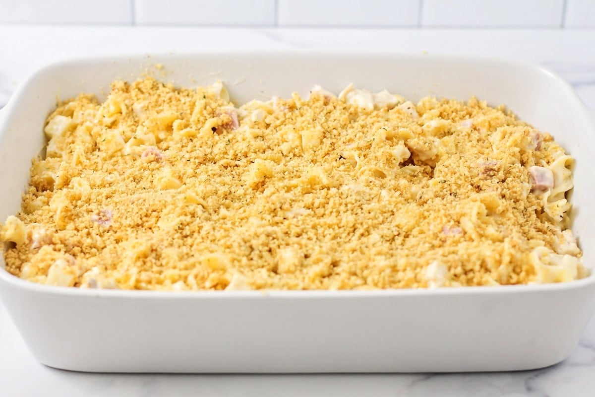 Sprinkling panko bread crumbs on top of casserole.