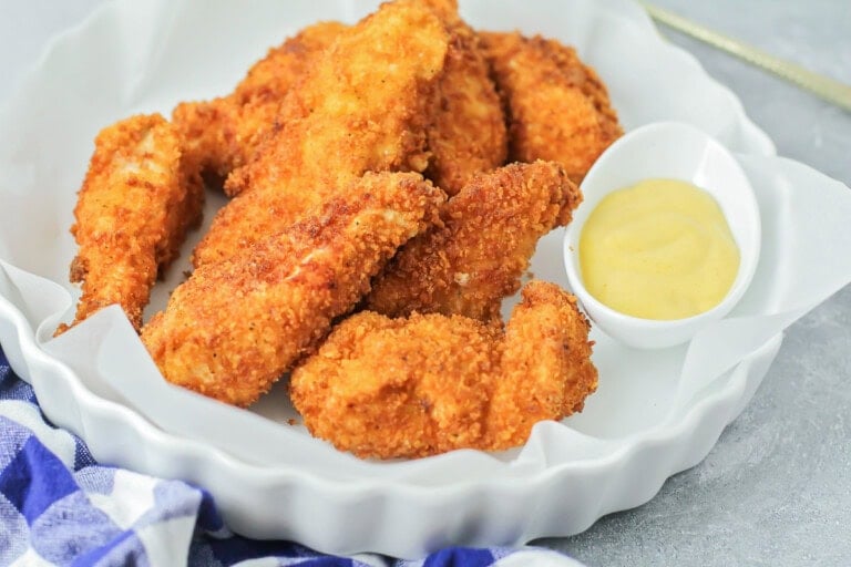 Fried chicken tenders served with dipping sauce.