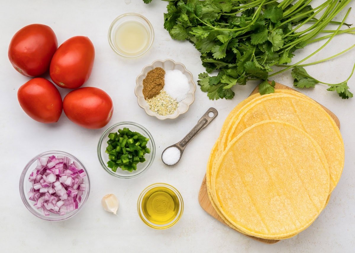 Ingredients for Chili's salsa recipe on a white countertop.