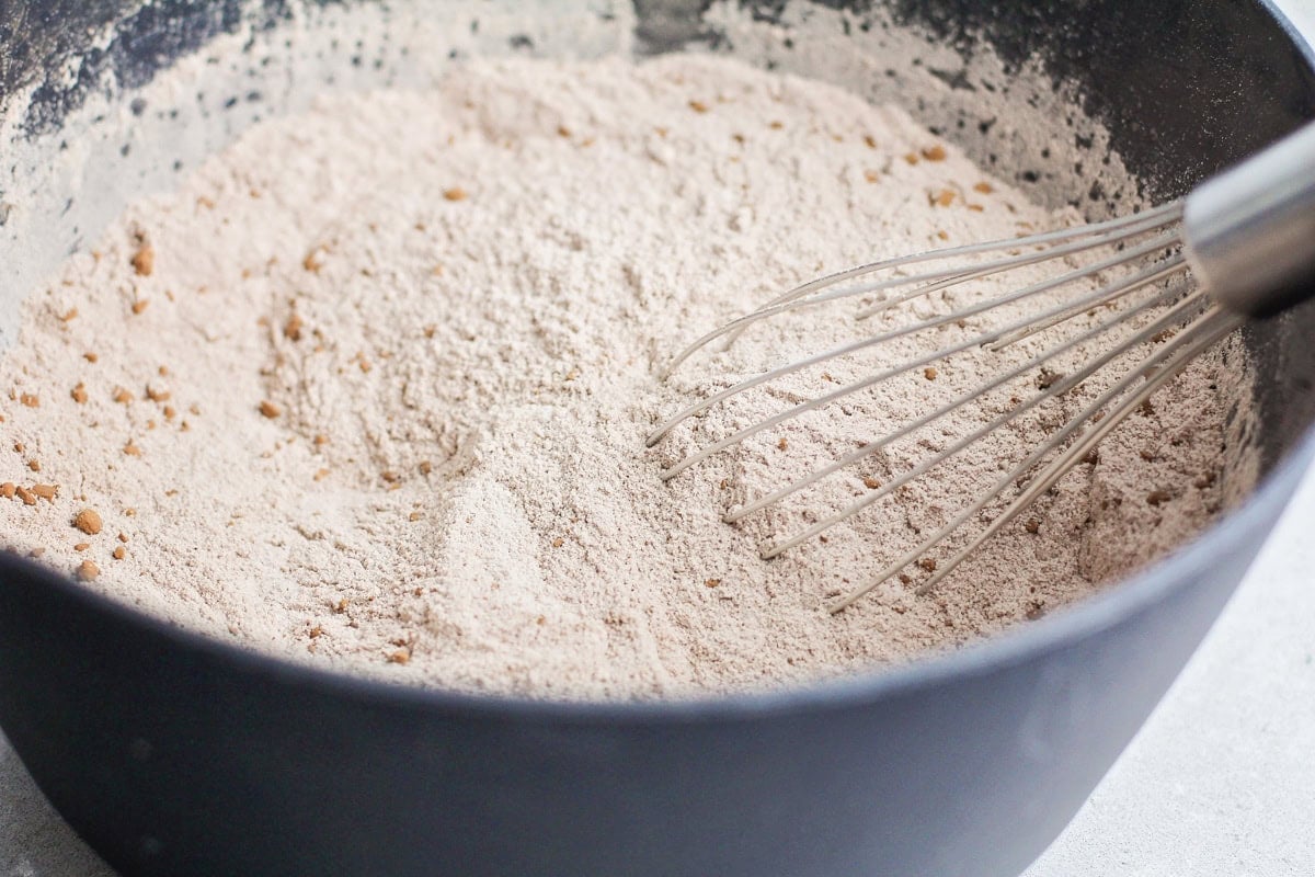 Flour and dry ingredients in a grey bowl.