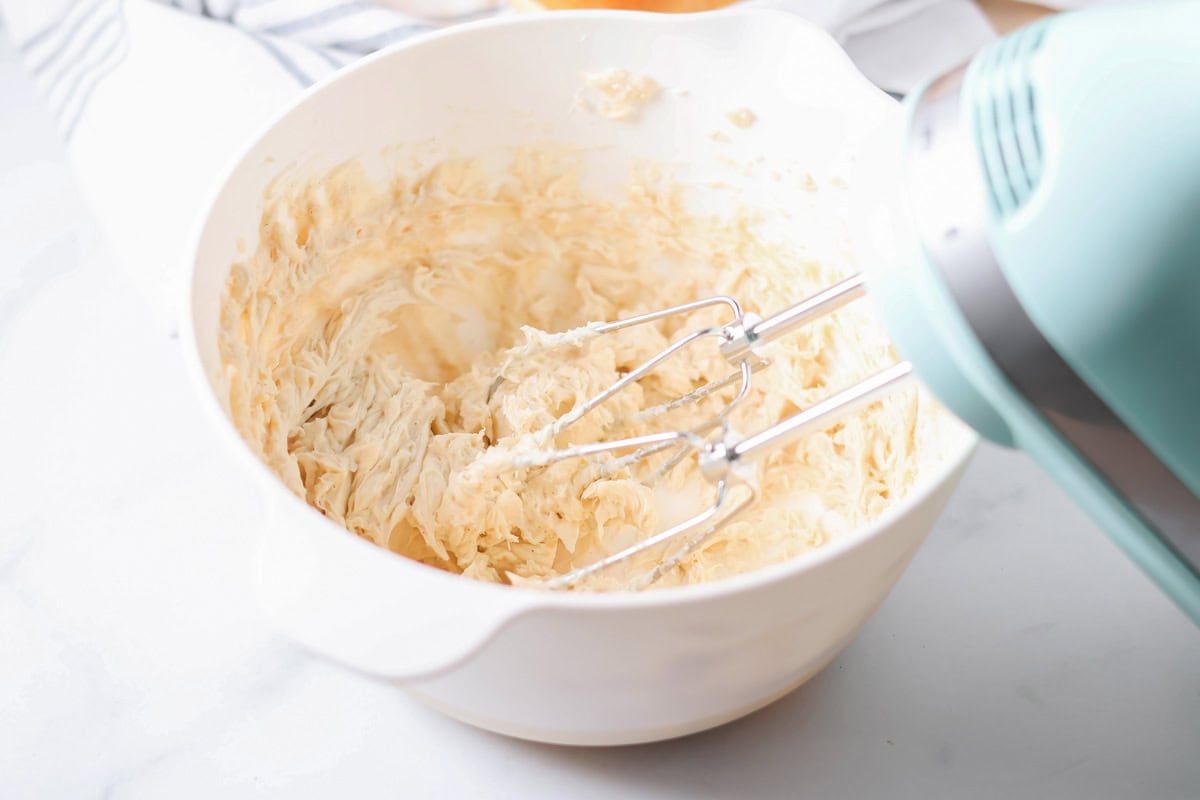 Sweet and fluffy cinnamon butter is whipped to perfection with 4 ingredients and 5 minutes, it's even better than Texas Roadhouse!! Mixing cinnamon butter ingredients with a handheld mixer.