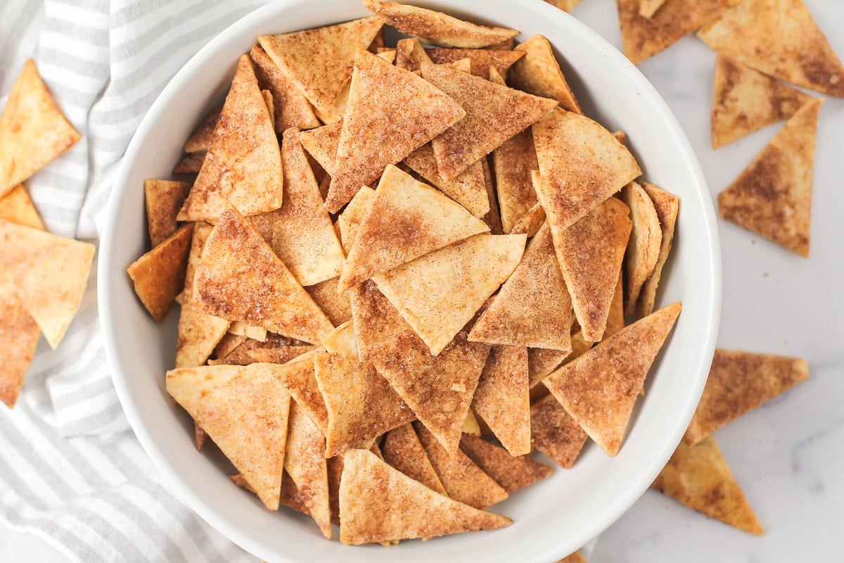 Homemade cinnamon tortilla chips in white bowl.