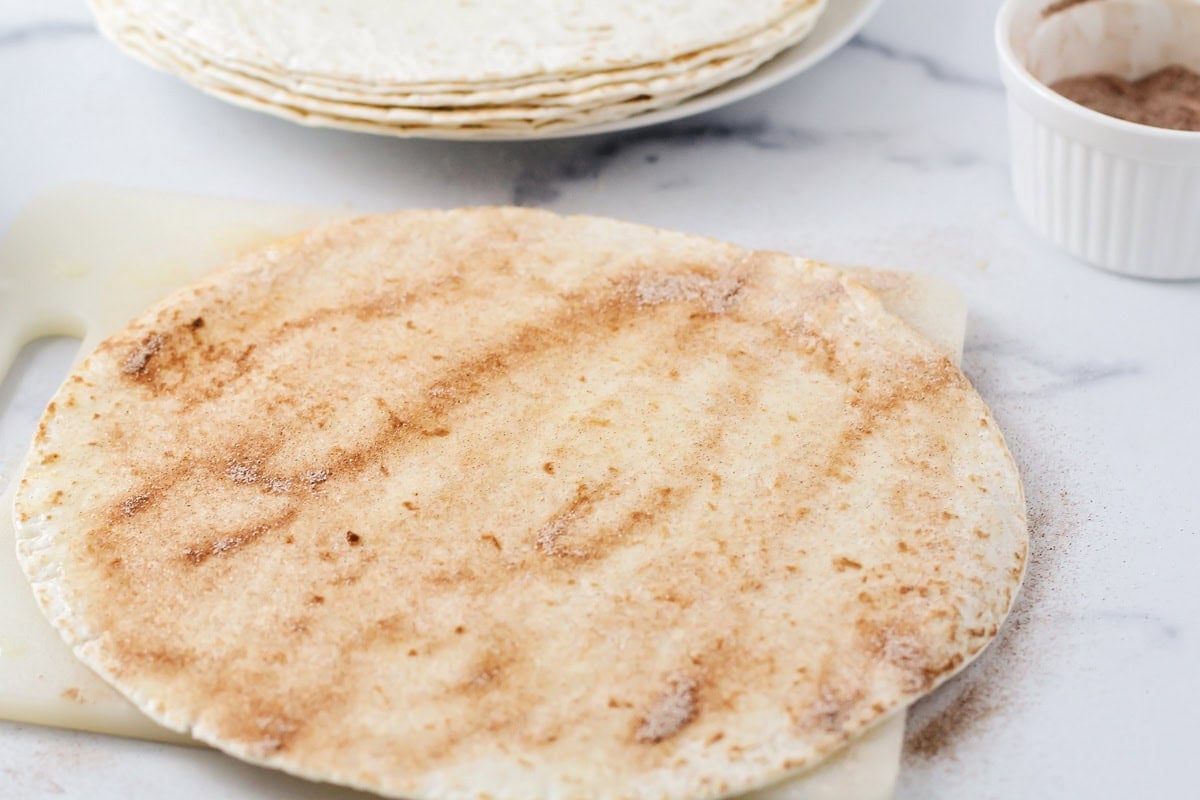 Tortillas with butter and cinnamon and sugar spread over it.