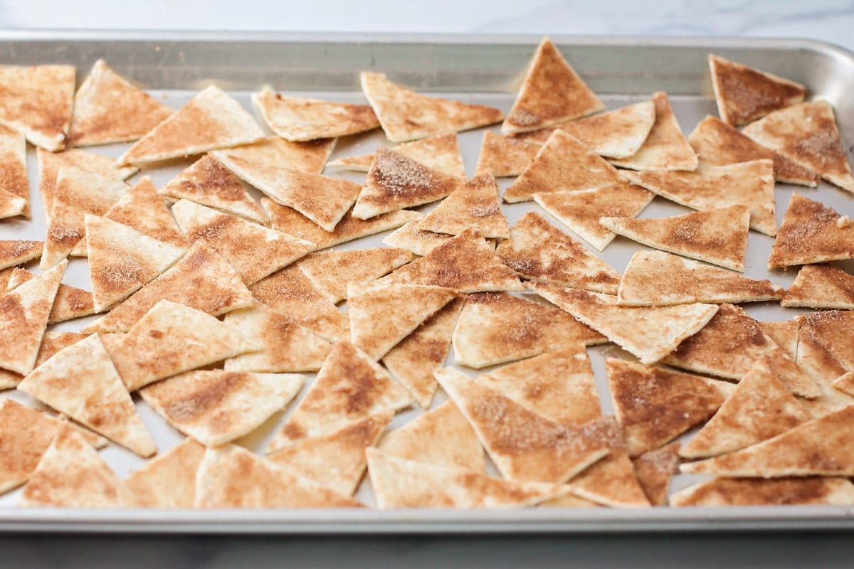 Cinnamon tortilla chips on baking sheet.