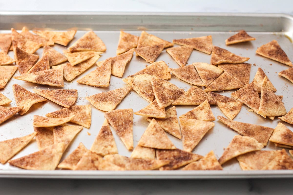 Baked cinnamon chips on baking sheet.