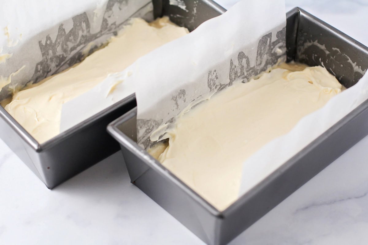 Adding cream cheese layer to the batter filled bread pans.