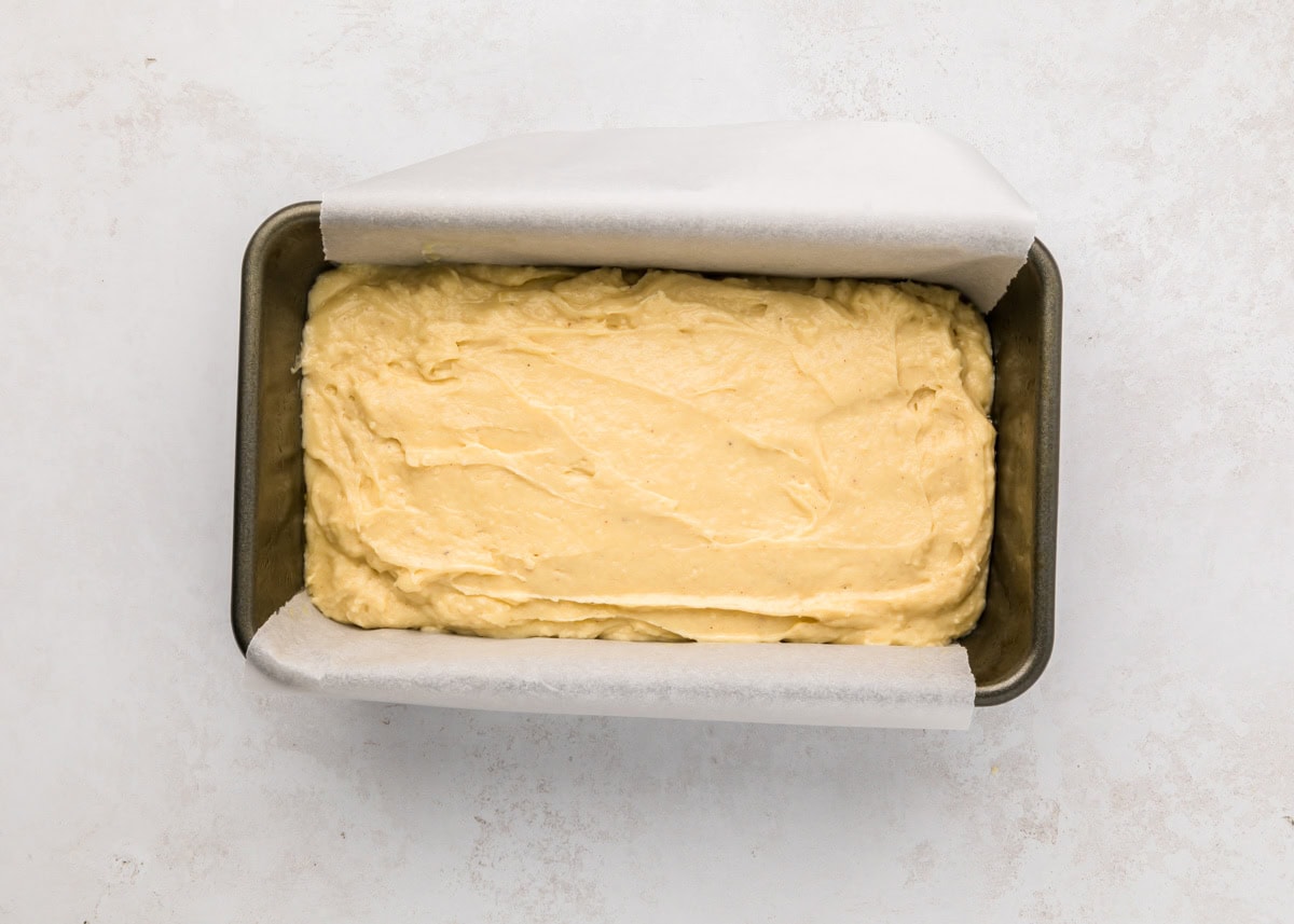 Eggnog bread batter poured into bread pans.