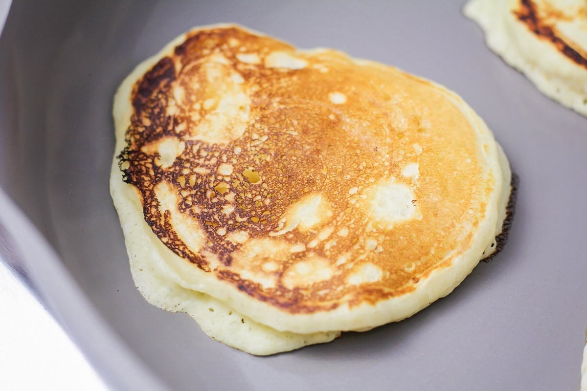 A golden brown pancake in a skillet.