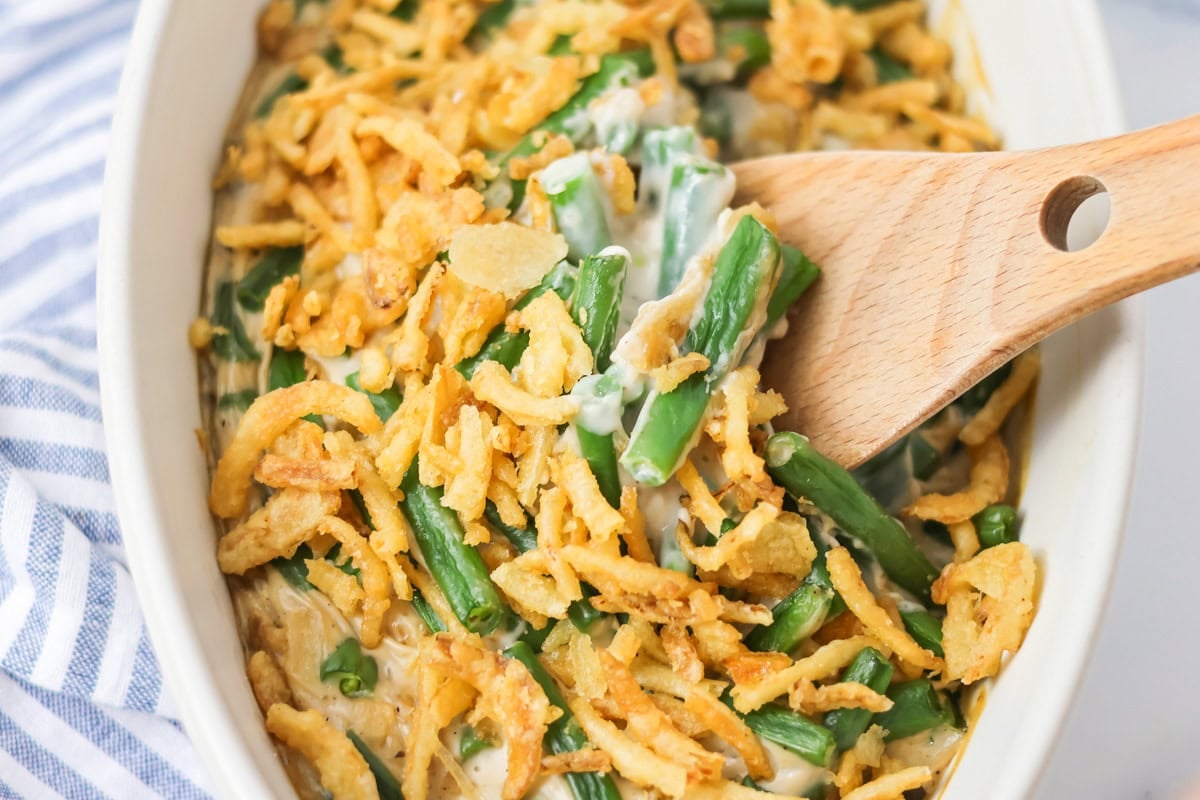 Fresh green bean casserole served in a white casserole dish.