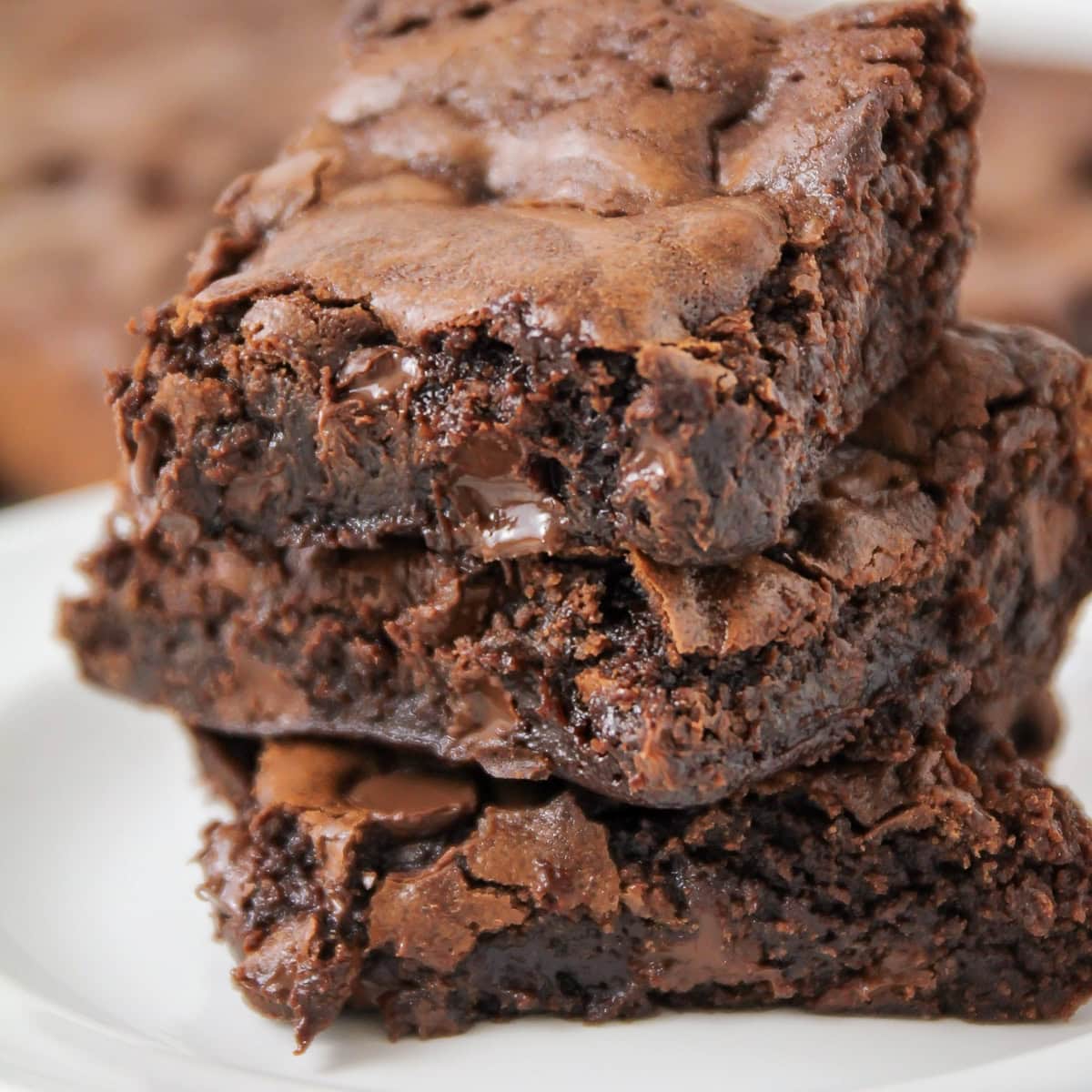 Close up image of homemade brownie recipe - stacked on top of each other on plate.