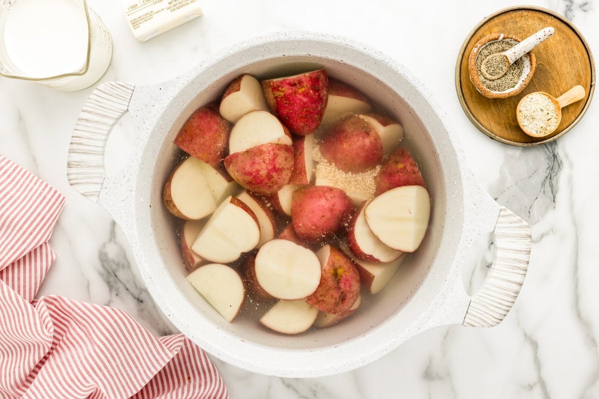 Boiling red potatoes in a pot.