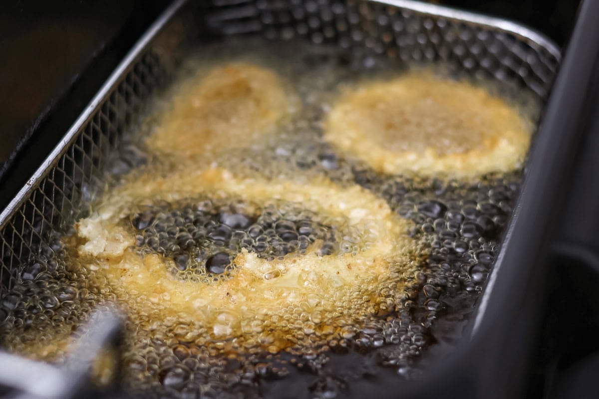 Onion rings frying in oil.