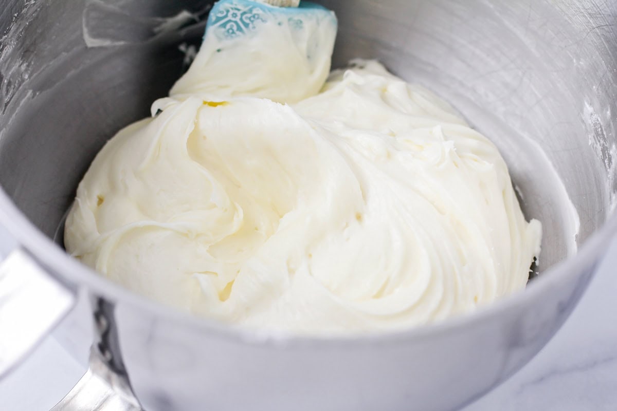 Whipped frosting in a metal bowl.