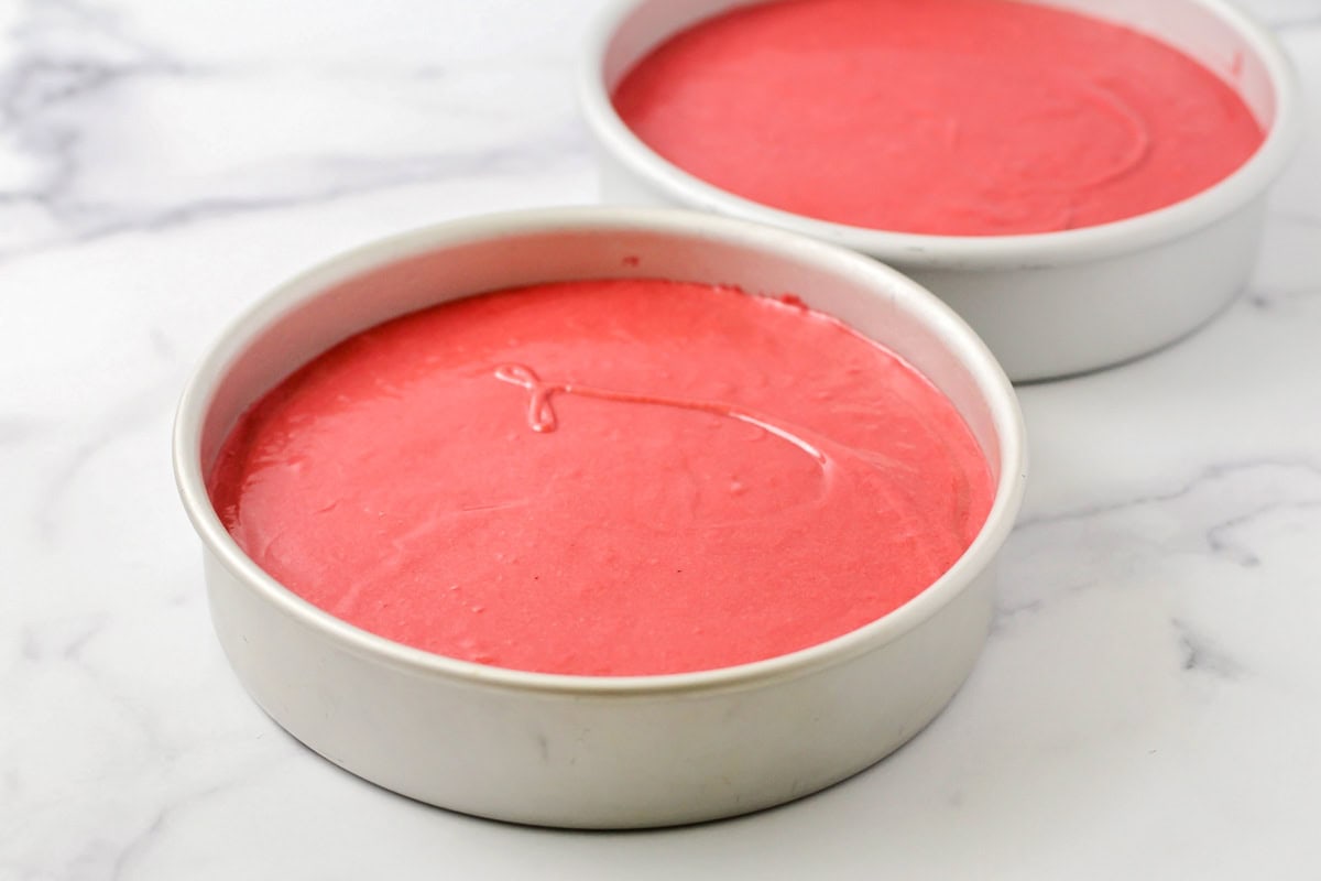 Two round pans filled with cake batter.