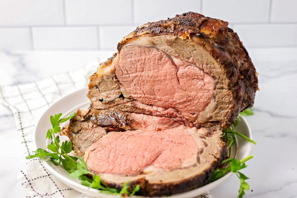 Ribeye roast recipe on white plate on counter.