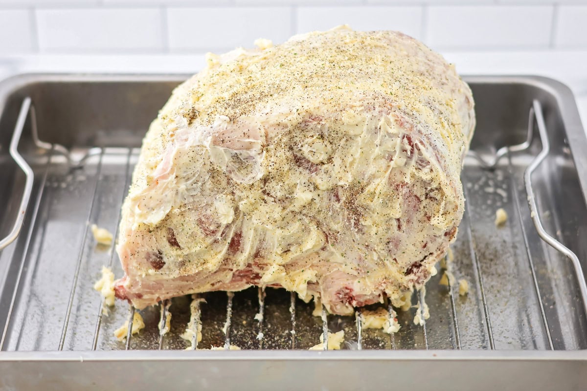 Seasoning the butter on the roast.