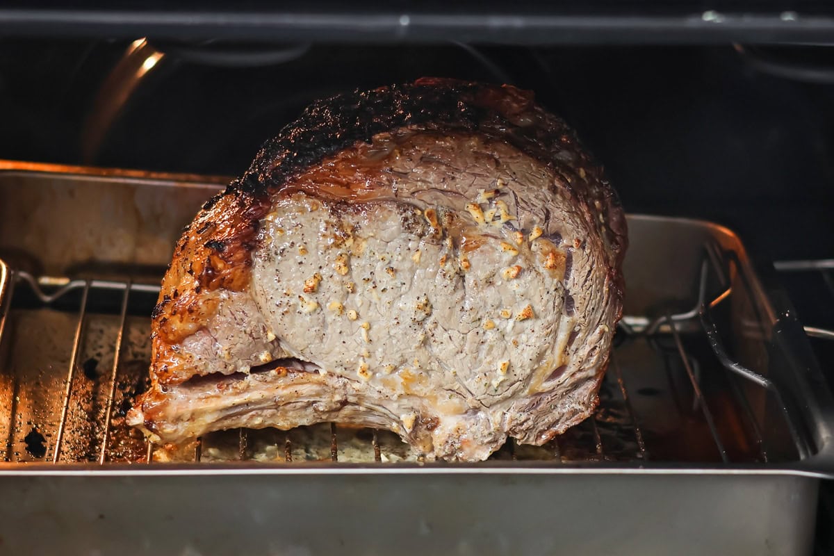 A roast on a pan in the oven.