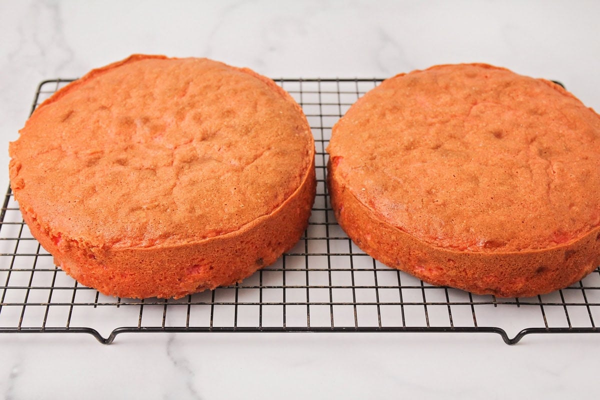 Homemade strawberry cake on cooling rack.