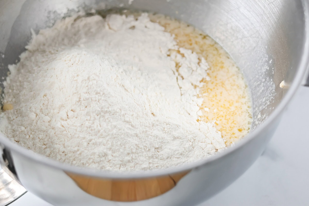 Combining ingredients for copycat Texas Roadhouse rolls in a large mixing bowl.