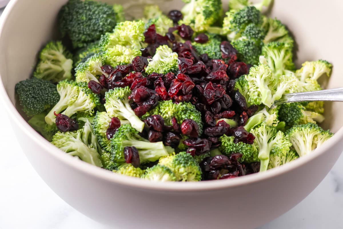 Broccoli and craisins in a bowl.