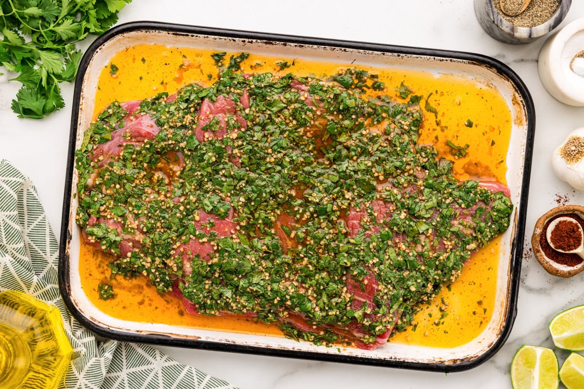Flank steak topped with marinade.