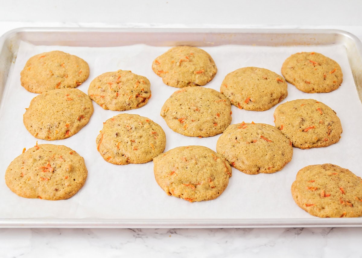 Carrot cake cookies baked on cookie sheet.