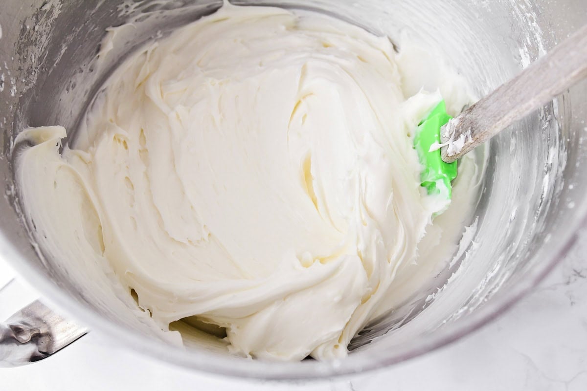 Frosting for carrot cake cookies in mixing bowl.