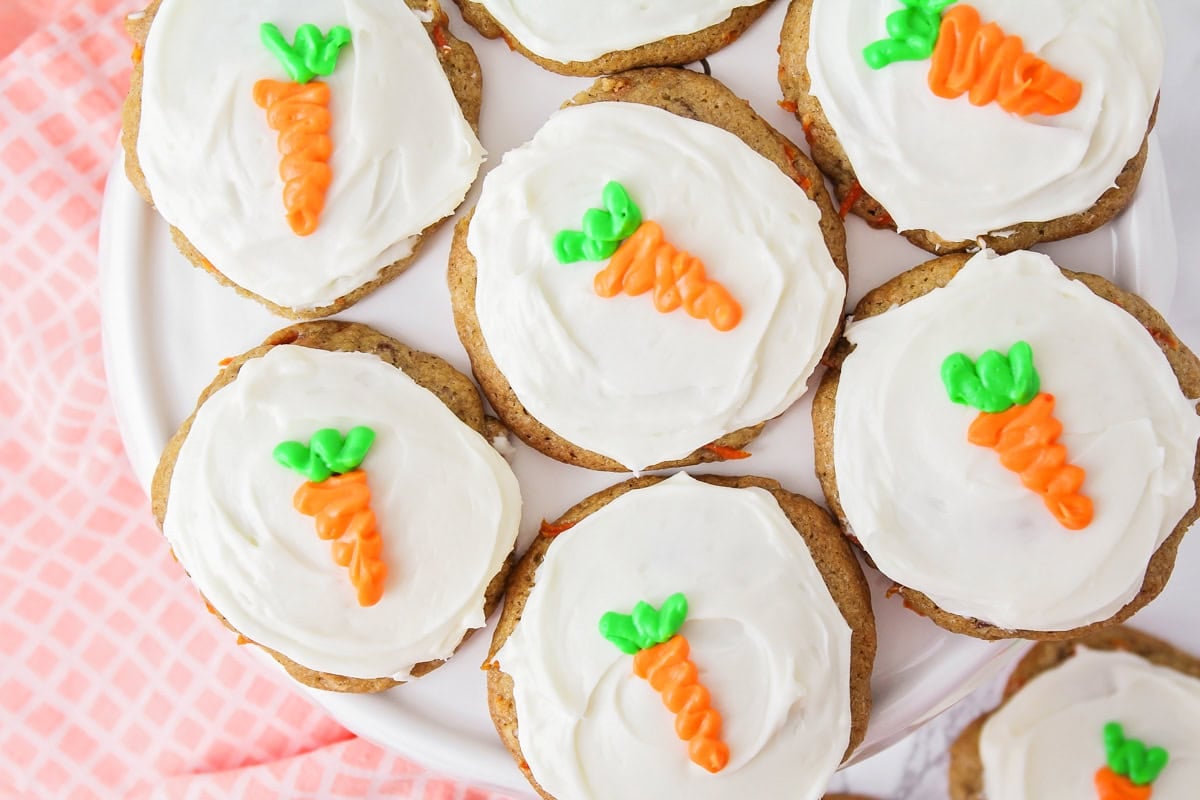 Close up image of carrot cake cookies on white cake stand.