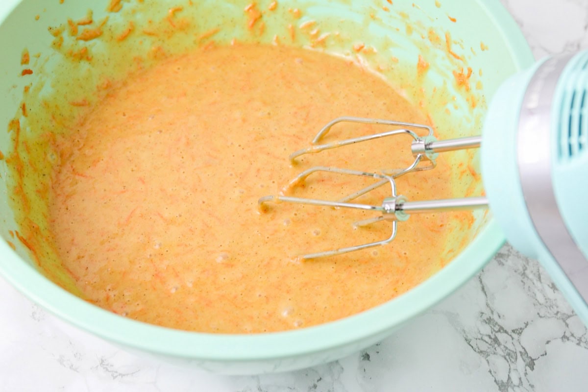 Carrot cake cupcakes ingredients mixed in mixing bowl.